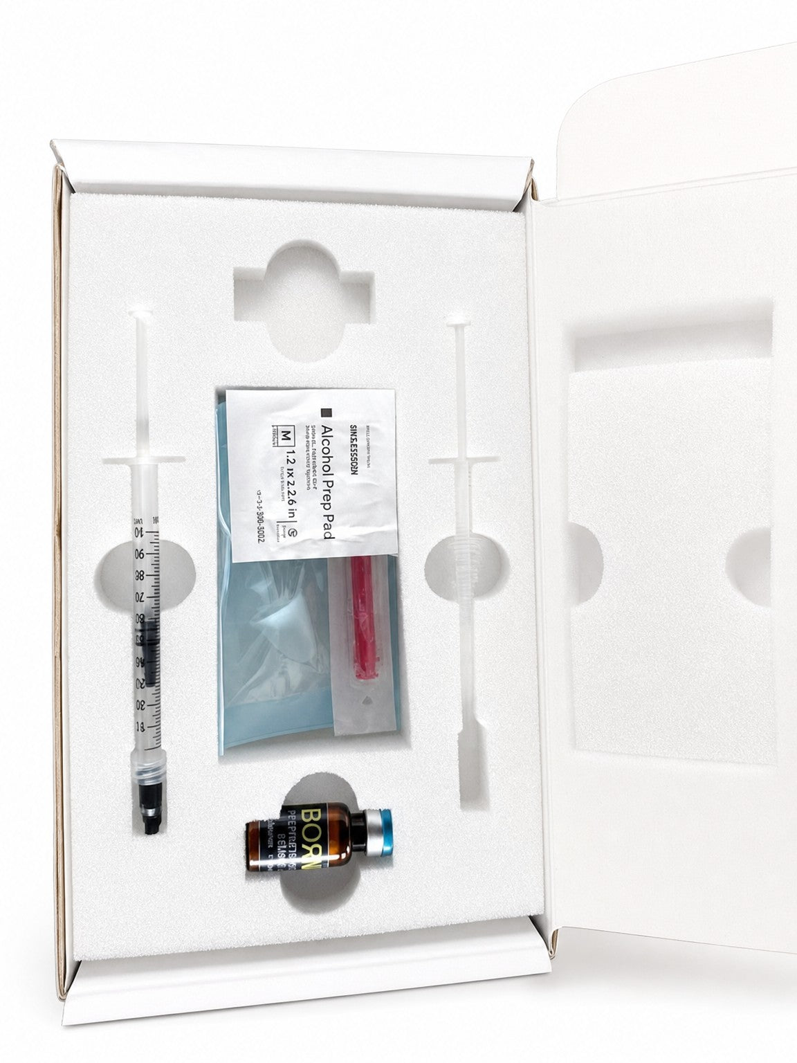 Rebornix at-home intranasal kit, opened: syringe, applicator, prep pad and vial in foam insert